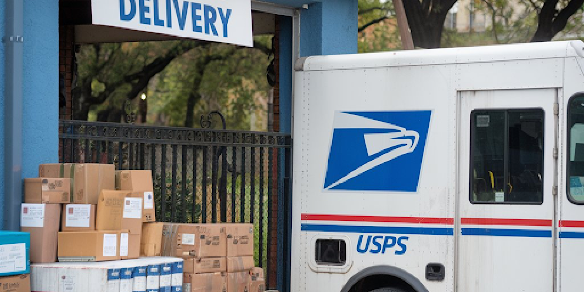 A USPS truck parked outside a building
